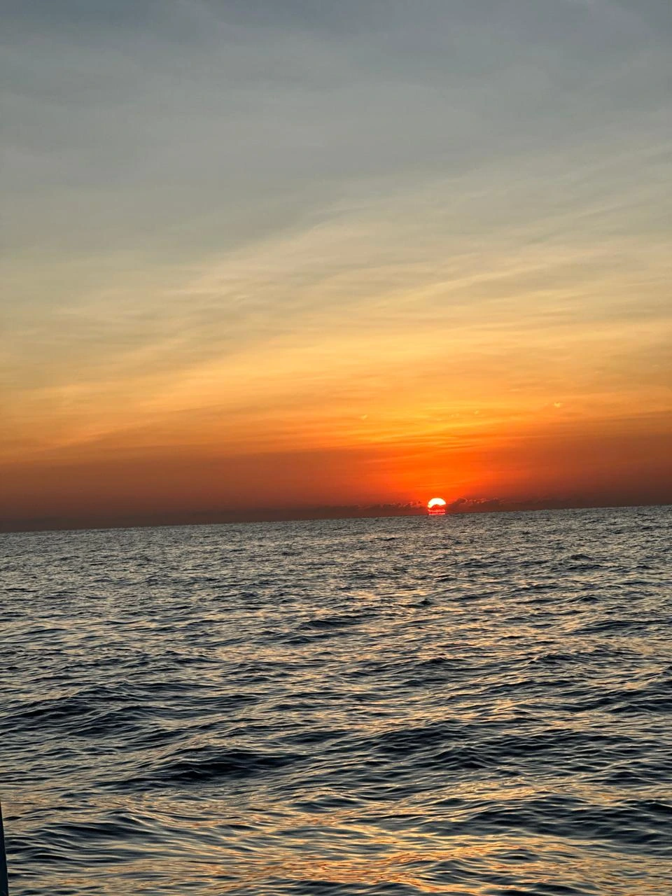 Sun setting over the open sea during a cruise in Amed