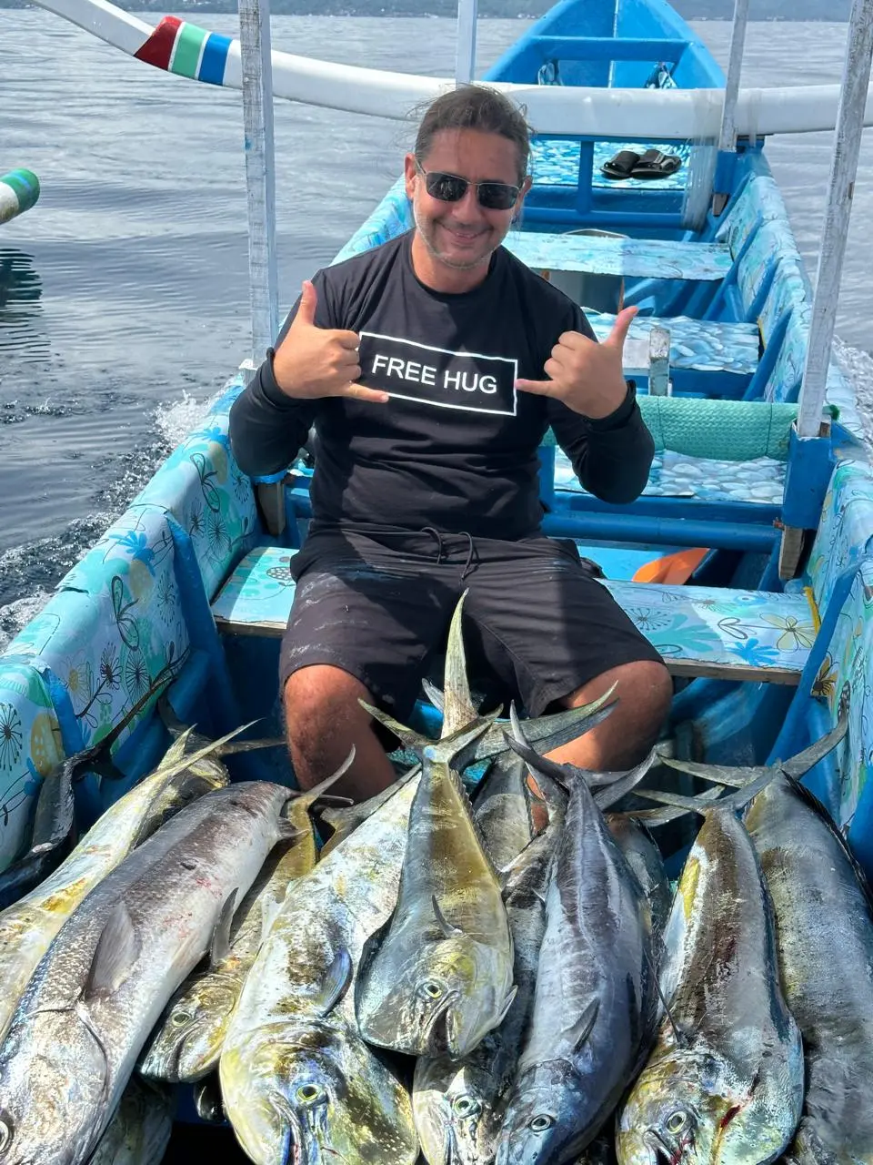 Two guests showing tuna caught on a fishing trip off Amed